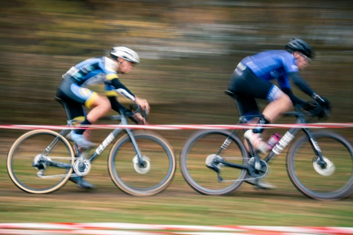 Two cyclists race on a dirt track